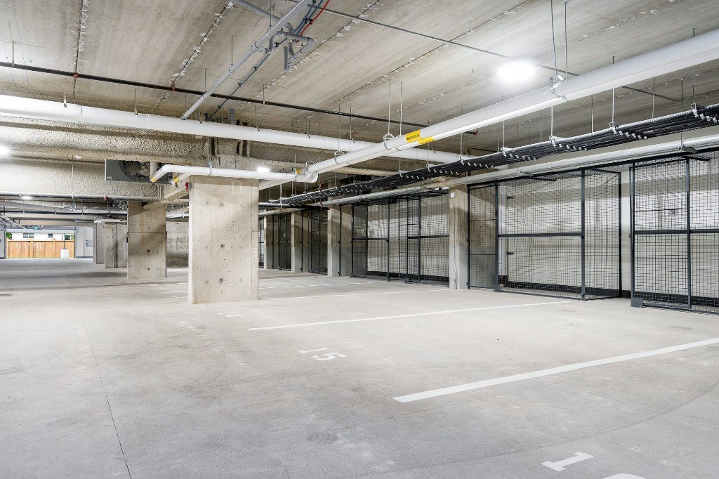 Underground parking stalls with resident storage lockers