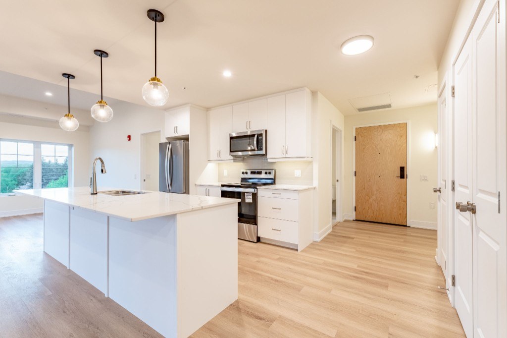 Suite 411 George model — open-concept kitchen and living area at X Creemore Condos